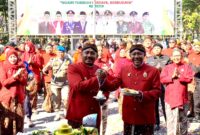 Bupati Ngawi Ony Anwar Harsono Menyerahkan potong tumpeng Kepada Wabup Ngawi Dwi Rianto Jatmiko dalam upacara Hari Jadi Ngawi ke-668 di Halaman Pendopo Wedya Graha. ( Septian Bayu/Ngawi).